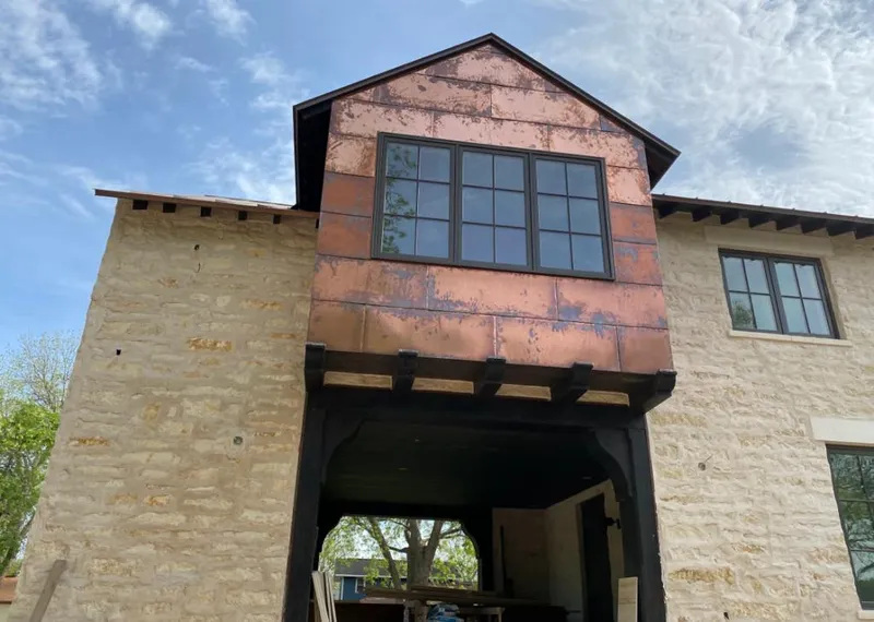 Copper metal panel facade on a stone building for Skylight Installation in Bonney Lake